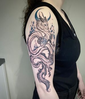 Illustrative Ink brush style dragon and blue moon on arm 