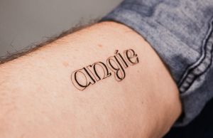 Get a timeless and sophisticated look with this beautiful lettering tattoo created by skilled artist Gabriele Edu.