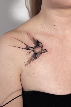 Beautiful black and gray tattoo of a bird swallow, skillfully done by Ion Caraman, featuring intricate details and shading.