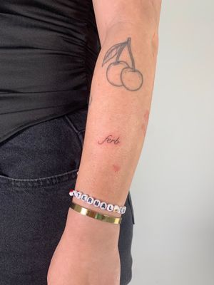 Get inked with delicate small lettering by tattoo artist Chloe Hartland. Embrace minimalism with this elegant fine line tattoo.