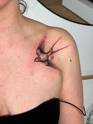 Capture the beauty of nature with this black and gray illustrative swallow tattoo by the talented artist Ion Caraman.