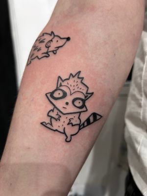 Add a touch of whimsy to your body with this illustrative and charming raccoon tattoo by the talented artist Jonathan Glick.