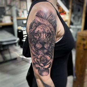 Realism black and grey piece of a lion and rose