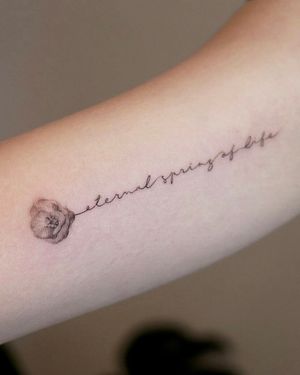 Delicate lettering tattoo with camellia flower