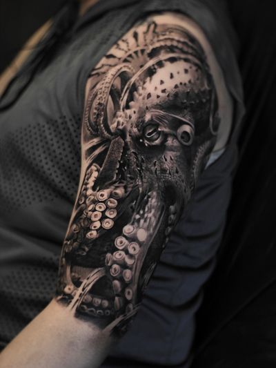 a very detailed octopus on the shoulder in the style of black and gray realism with the addition of elements according to the client's idea