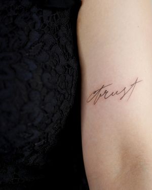 Io's custom calligraphy style lettering tattoo