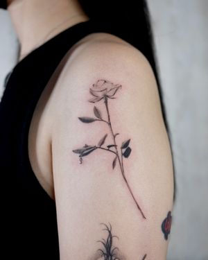 Abstract single rose tattoo