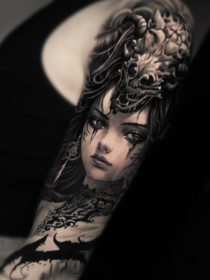 Immerse yourself in a mystical world with this stunning realism tattoo by Santy Taiga, featuring a fierce dragon, skull, and powerful sorceress.