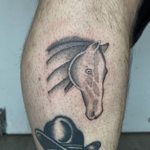 Ride into the realm of traditional tattoo art with this stunning black and grey horse design by Charlie Macarthur.