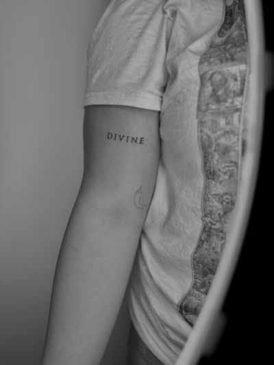 Delicate small lettering tattoo by Ruth Hall, conveying a message with subtle elegance.