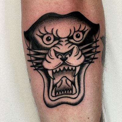 Experience the fierce beauty of a traditional panther tattoo expertly done by renowned artist Marc 'Cappi' Caplen.