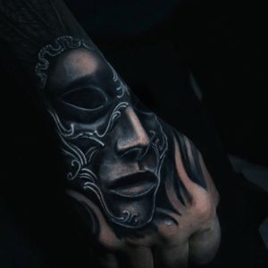 Venetian mask hand tattoo.