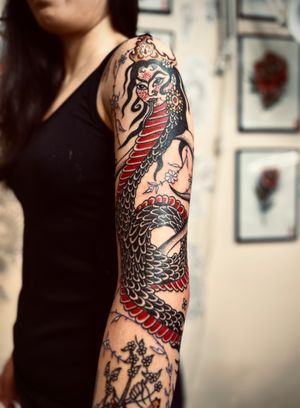 Illustrative tattoo combining sea, snake, dragon, and nure onna motifs by artist Omar Al Kaissi.