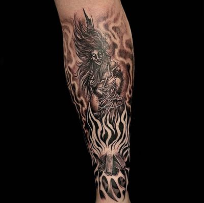 Embrace the enchanting power of this illustrative dotwork tattoo by the talented artist Ker Kusterbeck, featuring a mystical witch surrounded by a blazing bonfire.