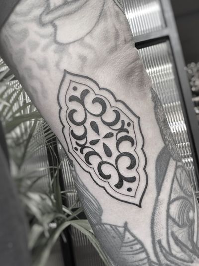 A mesmerizing blackwork tattoo by Oliver Whiting featuring a detailed ornamental pattern design.