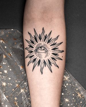 Unique blackwork tattoo by Alexandra Mulhall featuring a sun, eye, and woodcut engraving in medieval style.