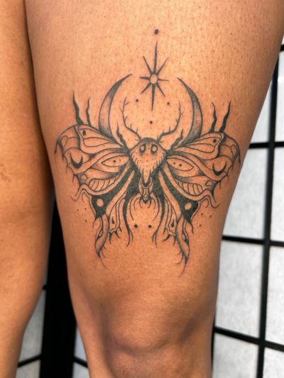 Capture the magic of the moon and stars with this captivating blackwork moth tattoo design by Jonathan Glick.