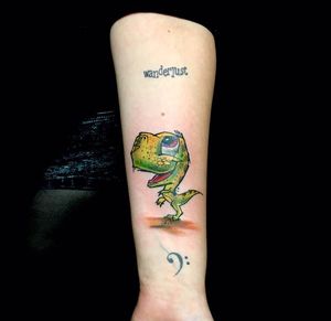Get a unique and colorful dino tattoo by the talented artist Sandro Secchin. Stand out with this eye-catching piece!