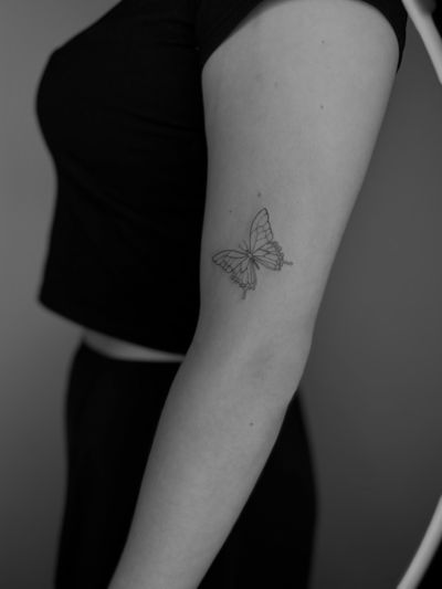 Fine line and illustrative butterfly tattoo by Ruth Hall, showcasing intricate and delicate details.