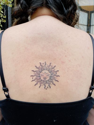 Intricate dotwork and fine line style sun motif by Laura, creating a mesmerizing ornamental design.