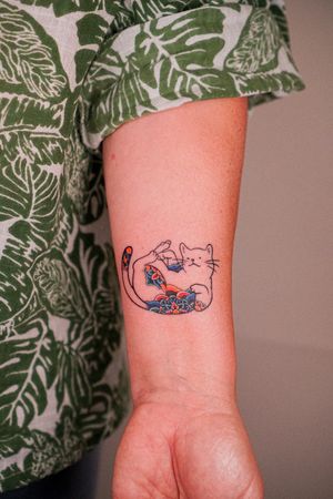 Experience the beauty of Asian tradition with this stunning cat tattoo featuring delicate fine line details and vibrant watercolor accents. Created by the talented artist HWIZI.