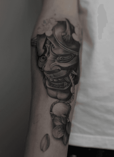 Get mesmerized by Kayla's intricate black and gray illustrative rendition of the haunting Hannya mask design.