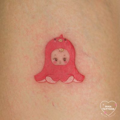 An adorable tattoo of a pastel octopus in anime style, featuring elements of Sanrio and Kewpie baby. Done by Mika Tattoos.