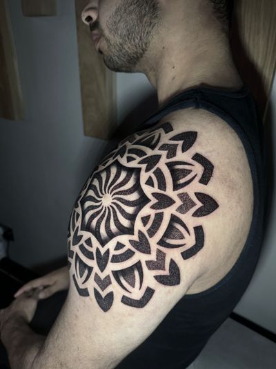 A stunning blackwork tattoo by Hamid featuring a detailed mandala pattern created entirely with delicate dots.