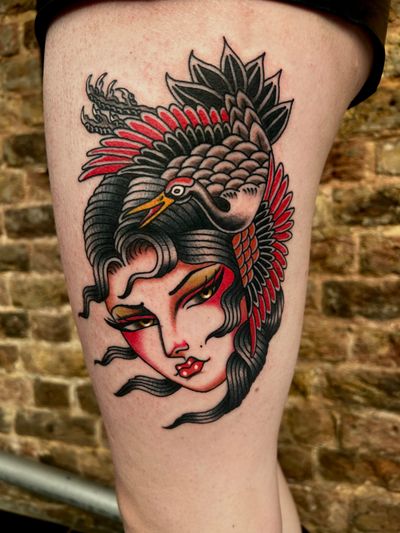 A stunning tattoo of a woman gracefully intertwined with a majestic crane in neo-traditional style by Barney Coles.