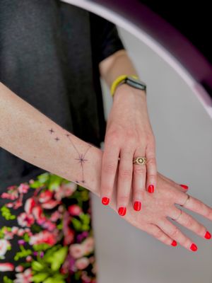 Fine line ornamental tattoo featuring a star constellation with twinkling sparkles, by artist Ruth Hall.