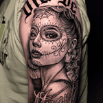 A stunning black and gray tattoo by Warren Mullins featuring a chicano style lady with a sugar skull motif, perfect for honoring Dia de Muertos.