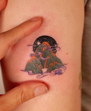 Capture the serenity of night with clouds, mountains, and fog in this illustrative tattoo by HWIZI.