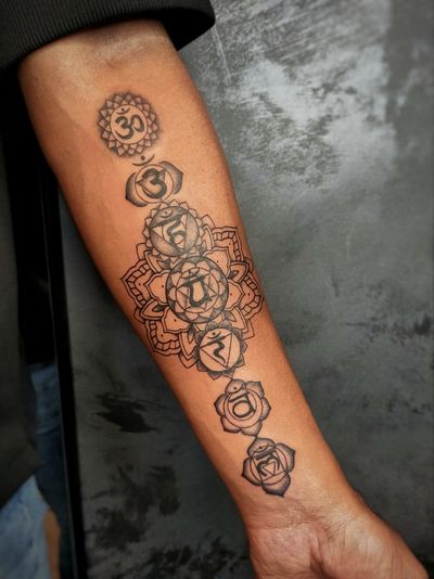 Fine line black and gray ornamental tattoo by Kateryna Goshchanska, featuring a detailed mandala design with a sacred Ohm symbol, inspired by Hindu culture.