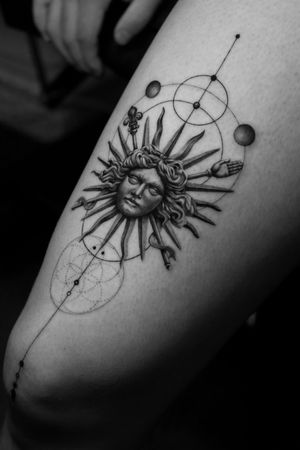 This black and gray fine line tattoo features a stunning blend of Greek and sun motifs, expertly executed by Light Grays in a geometric and micro-realism style.