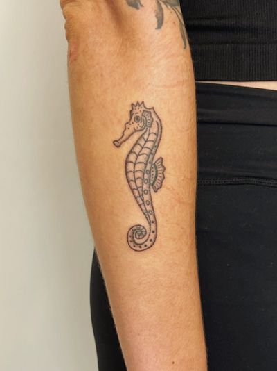 Unique hand-poked seahorse tattoo by artist Laura, featuring intricate dotwork design.