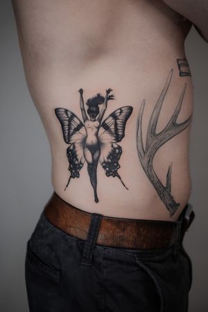 Beautiful finelined, black and grey butterfly winged fairy woman on ribs