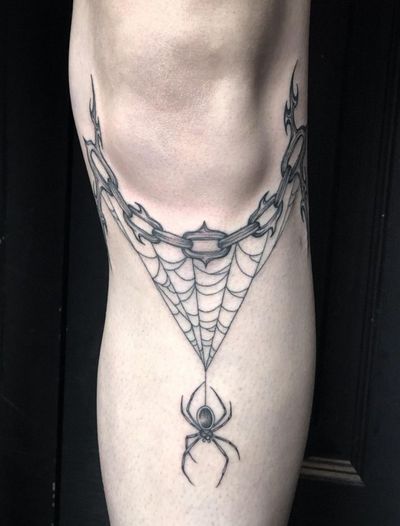 Mesmerizing black and gray illustrative tattoo of a spider wrapped in chains on a web, expertly done by Amandine Canata.