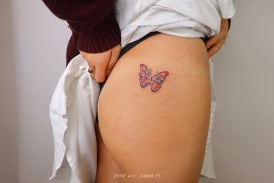 An illustrative tattoo of a butterfly made with crayon style strokes, featuring Korean motifs by artist Eppie.