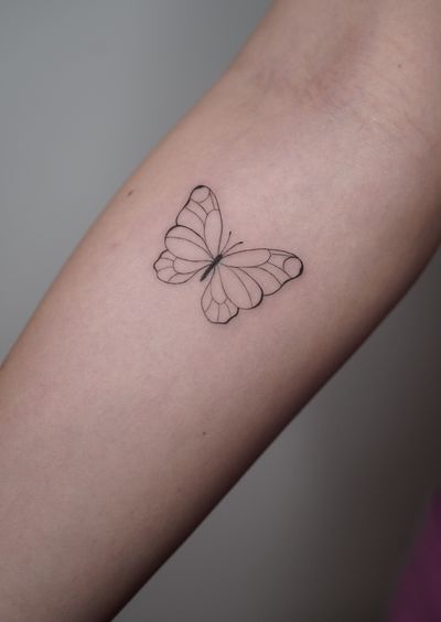 Delicate fine line butterfly design by Ally.ink, showcasing elegant and simplistic beauty.