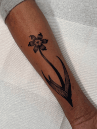 Black & grey Bermudiana flower on melanated skin, scar cover up.