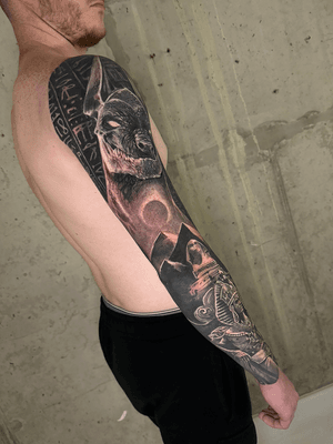 black and grey egyptian full sleeve realistic and surrealistic tattoo with cleopatra anubis hieroglyph pyramds, tattoo artist london uk