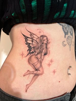 A stunning black and gray chicano style tattoo of a mystical fairy, intricately illustrated by Ion Caraman.