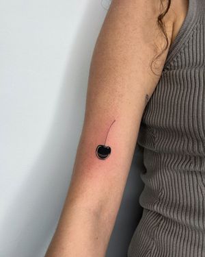 Unique blackwork cherry tattoo by Alessia Lo Piccolo, featuring intricate illustrative style details.