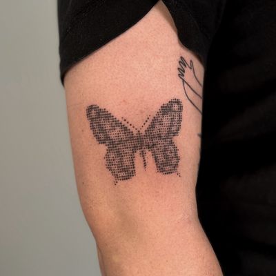 Black and gray tattoo by Jo Heatley featuring a butterfly design with intricate halftone patterns.