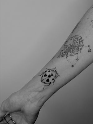Beautiful black and gray ladybird tattoo, delicately done in fine line style by the talented artist Ruth Hall.