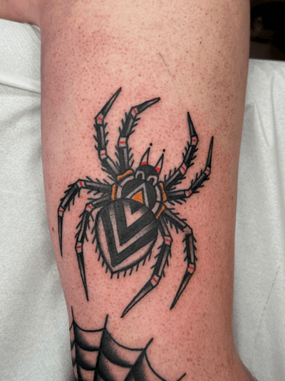 Get a creepy crawly traditional tarantula tattoo by the talented artist Jakob Isaac. Perfect for those who love a touch of darkness in their ink.