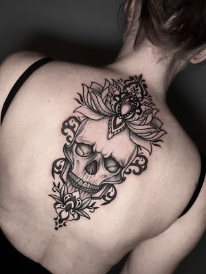 Unique dotwork style tattoo by Hamid featuring a lotus flower, skull, and jewel motif.