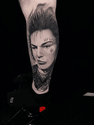 Get a badass punk rock tattoo with this black and gray realism portrait of Sid Vicious by the talented artist Mauro Imperatori.