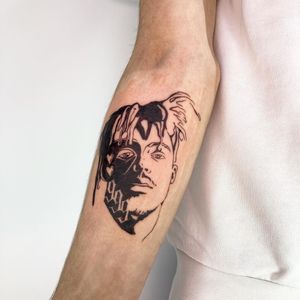 Express your love for Juice WRLD with this illustrative blackwork tattoo featuring music motifs. Designed by the talented artist, Robert Buckley-Warner.