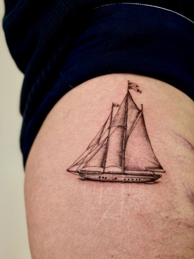 Black and gray illustrative sailboat tattoo by Ruth Hall, showcasing intricate details in a small-scale design.